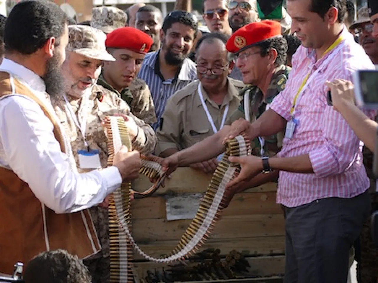 TripoliWeaponsHandoverII A member of the Zawiya brigade (left) hands in his weapons cache. (Photo: George Grant)
