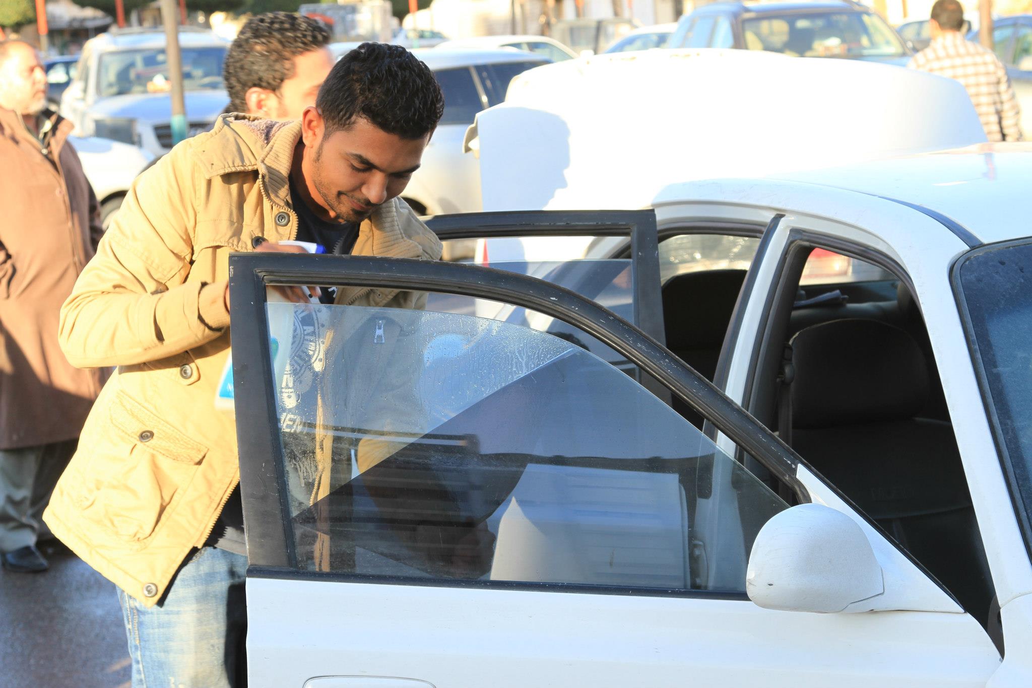 Misrata youth remove tinted car windows