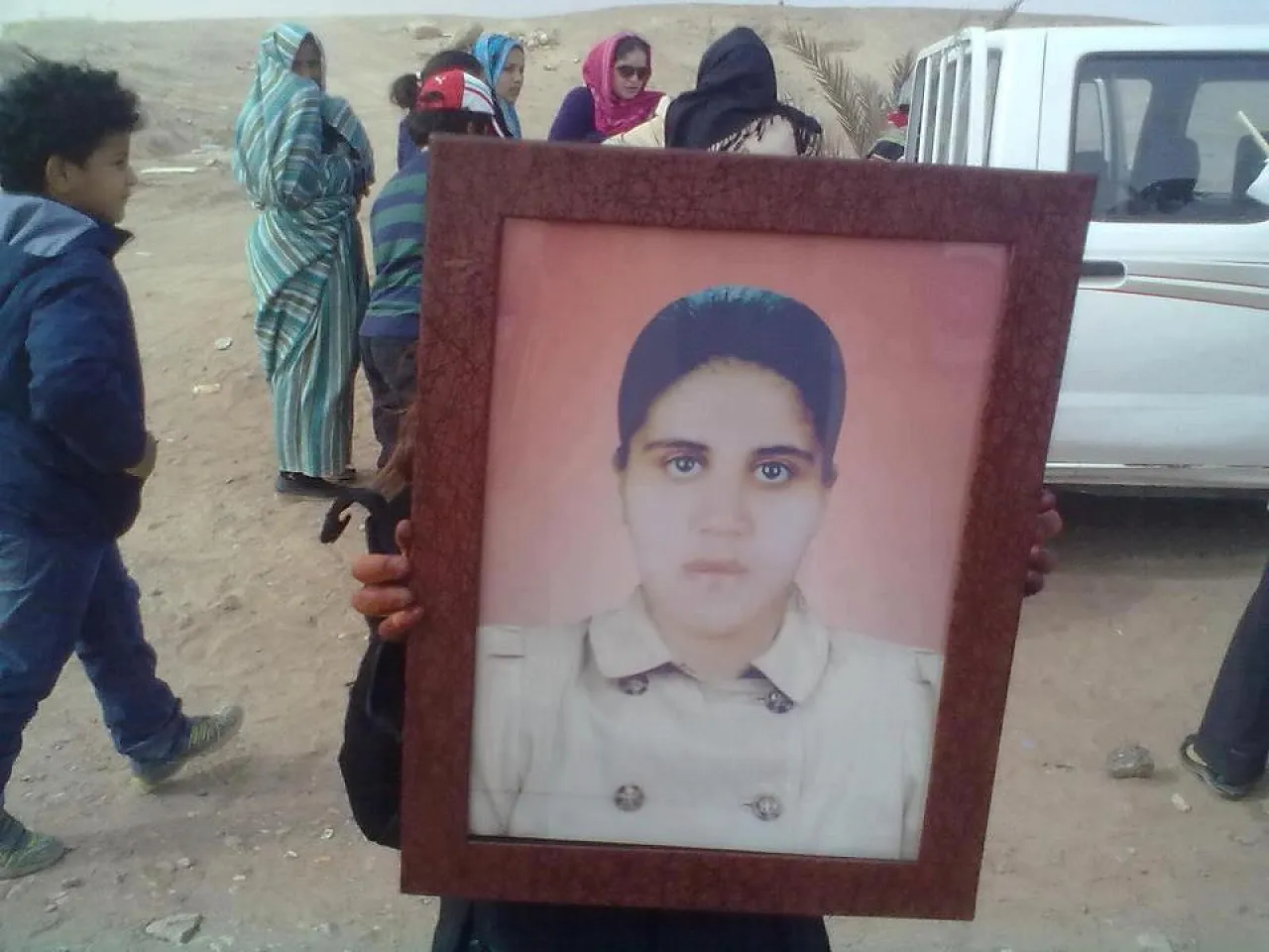 Senussi sit in 2 Protestor with a picture of Unood Senussi