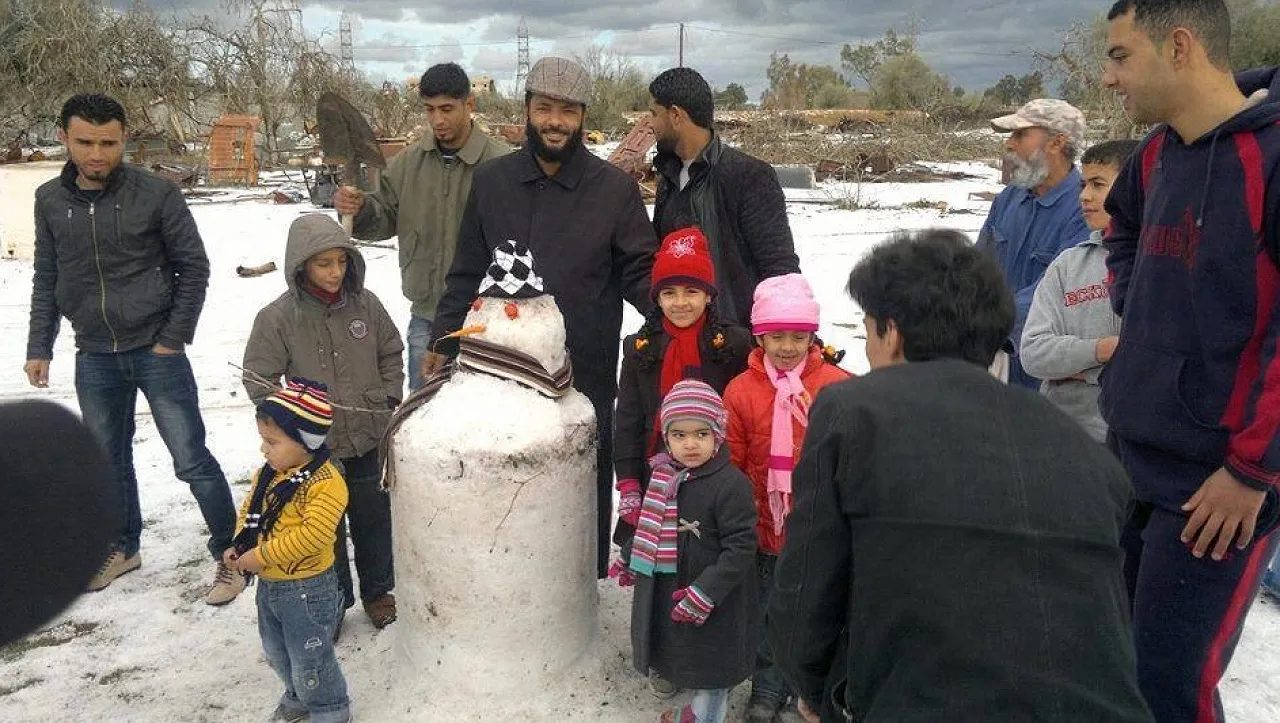Snow in Zawia Snow may be a novelty but kids quickly work out what to do with it