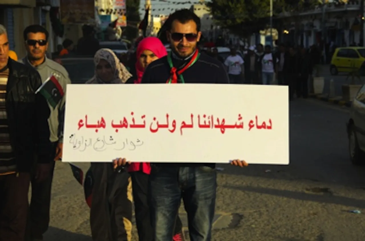 "The Blood of the Martyrs will not go in vain" reads one marcher's banner