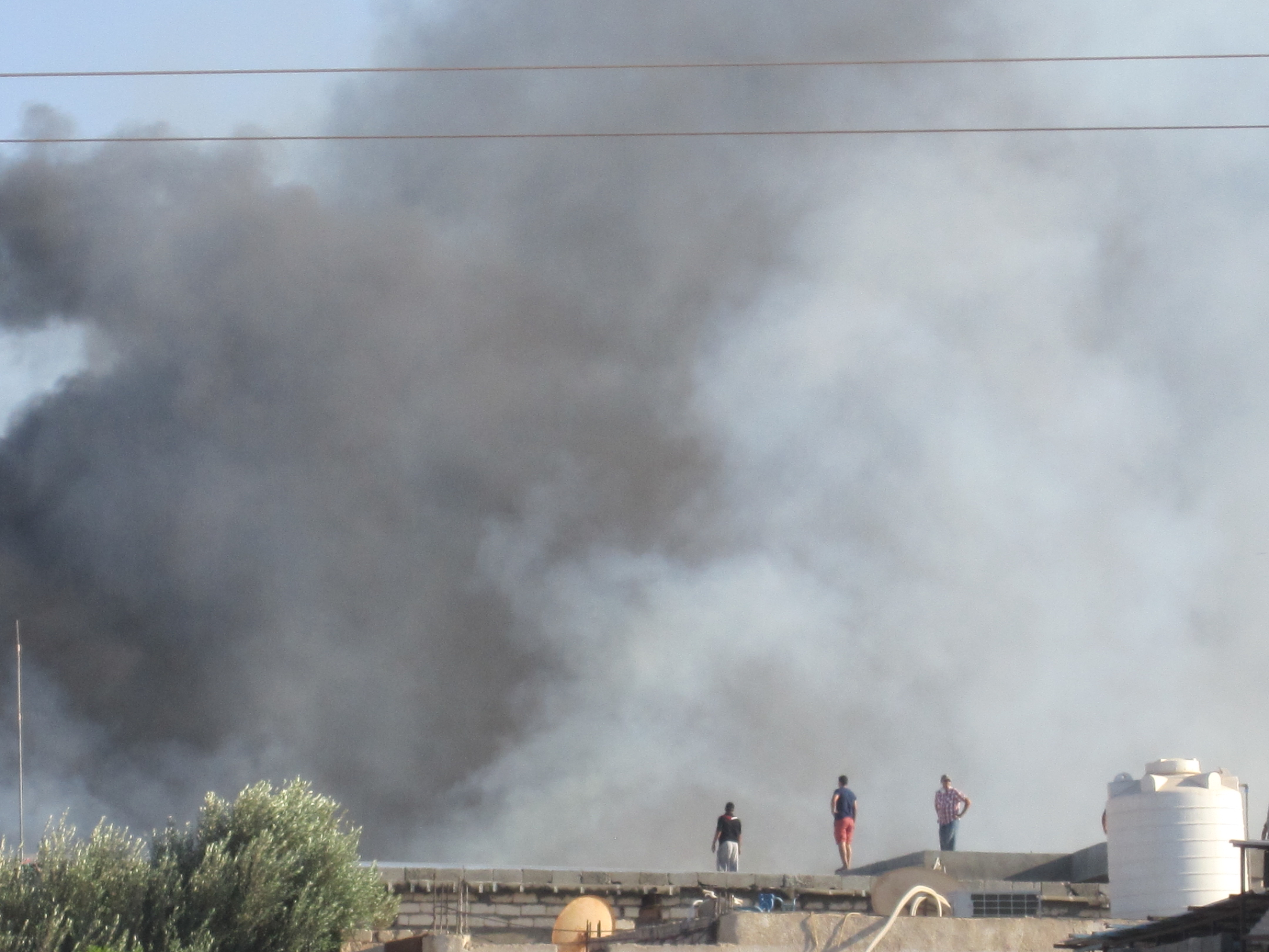 Tripoli fire fighters call for support to control warehouse blaze