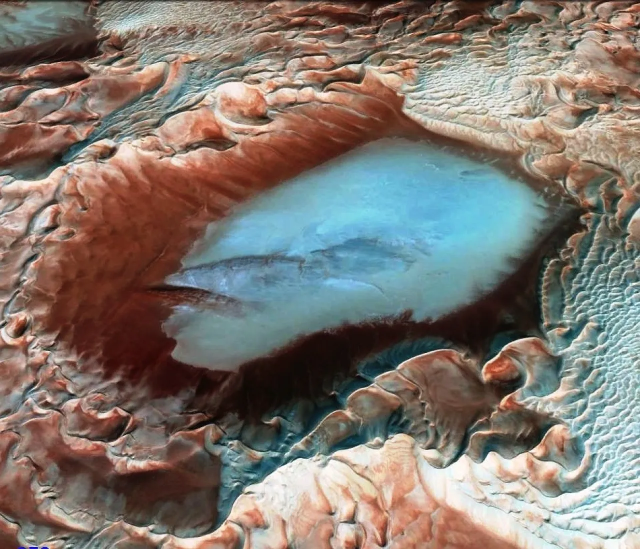 Figure 2: A close-up of one of the numerous dry lakes within the Murzuk Sand Sea. Thanks to Google Earth for the extraordinary three-dimensional details of the various sand dunes. Note the old lake deposits which give good rock exposure at the lowerside of the lake.