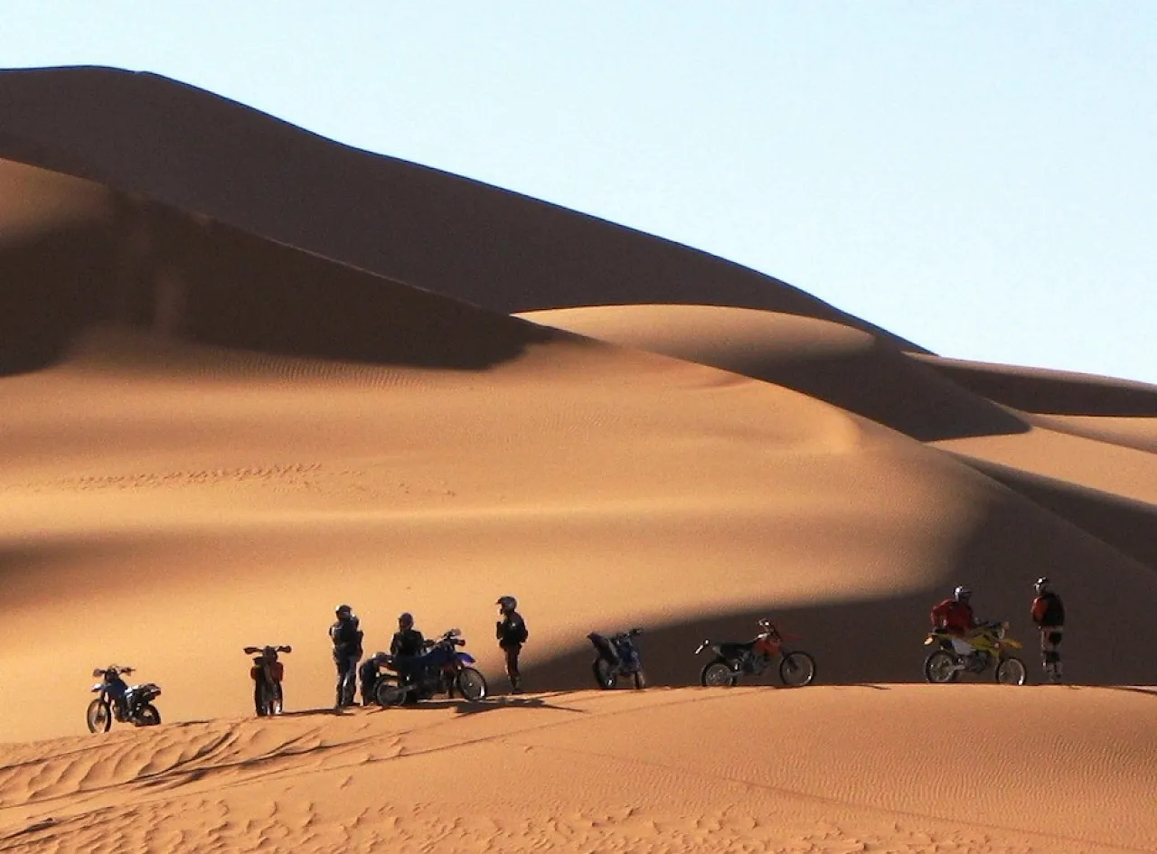 Figure 7: Motorbikes at Idhan Murzuk. These adventurers on motorbikes or quads have a considerable impact on the landscape and its archaeological content, with very little return to the tourism industry in Libya. They are also involved in frequent tragic accidents in the remote desert due to their reckless driving in the rugged terrain. (Photo courtesy of MPFL Project) 